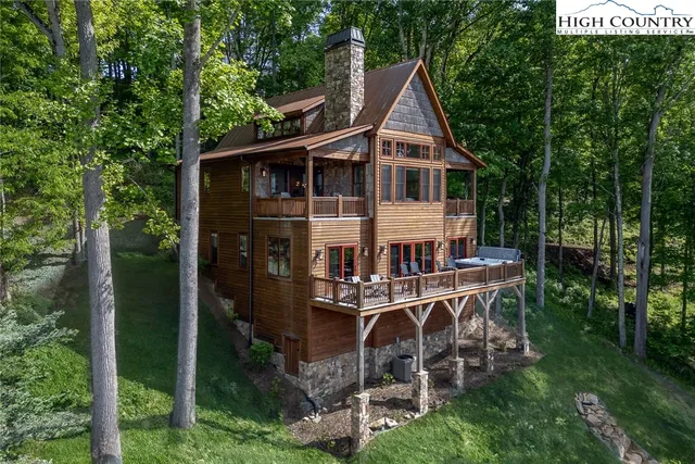 a view of a house with backyard sitting area and garden