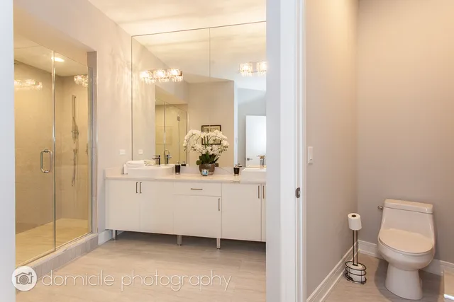 a bathroom with a shower sink and mirror