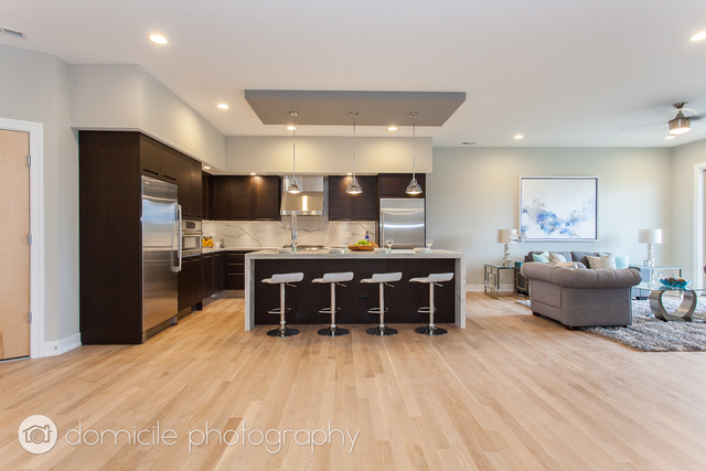 650 North Morgan Street, Unit 504 Chicago, IL 60642 - Photo 5 of 15 a living room with stainless steel appliances kitchen island granite countertop furniture and a kitchen view