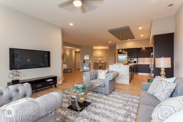 650 North Morgan Street, Unit 504 Chicago, IL 60642 - Photo 7 of 15 a living room with furniture and a flat screen tv