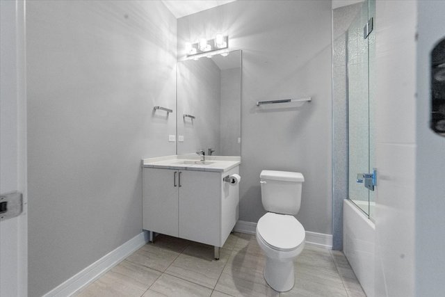 650 North Morgan Street, Unit 504 Chicago, IL 60642 - Photo 8 of 15 a bathroom with a toilet a sink and mirror