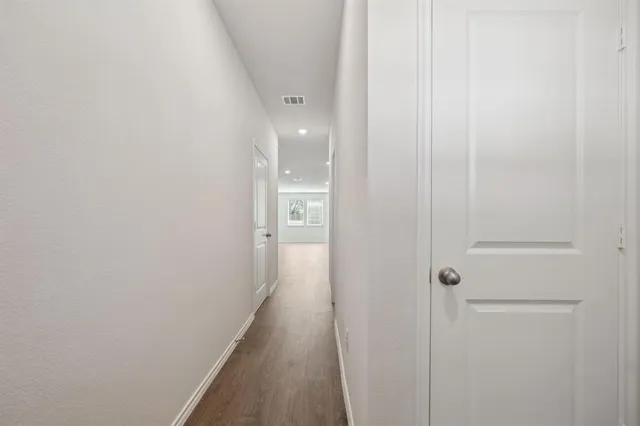 a view of a hallway with a wooden floor