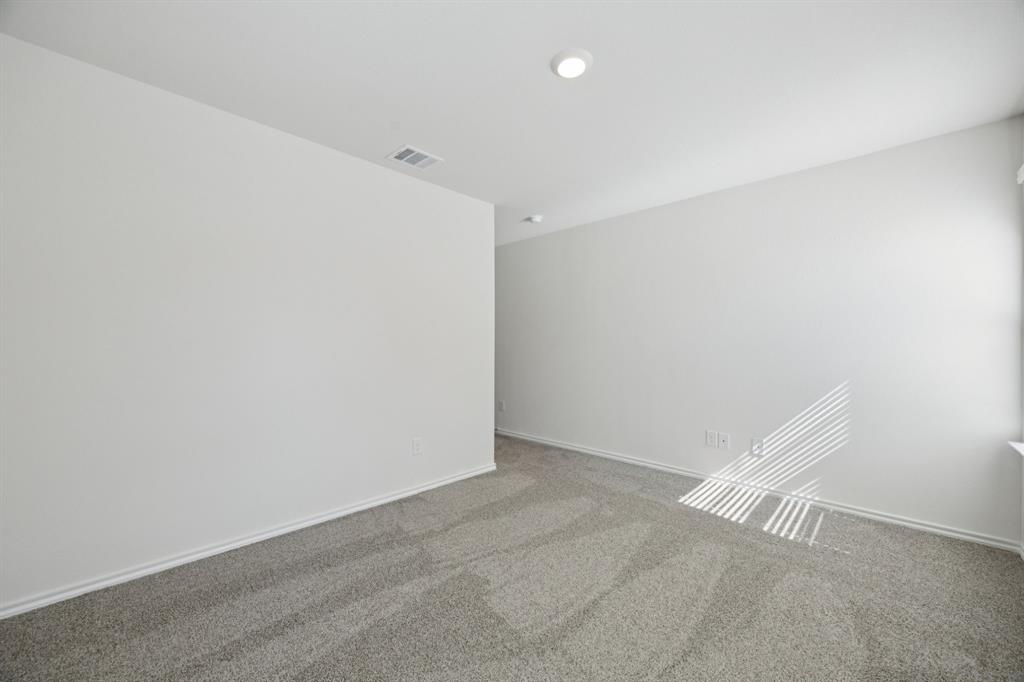 323 Clematis Street Princeton, TX 75407 - Photo 22 of 34 Carpeted empty room with baseboards
