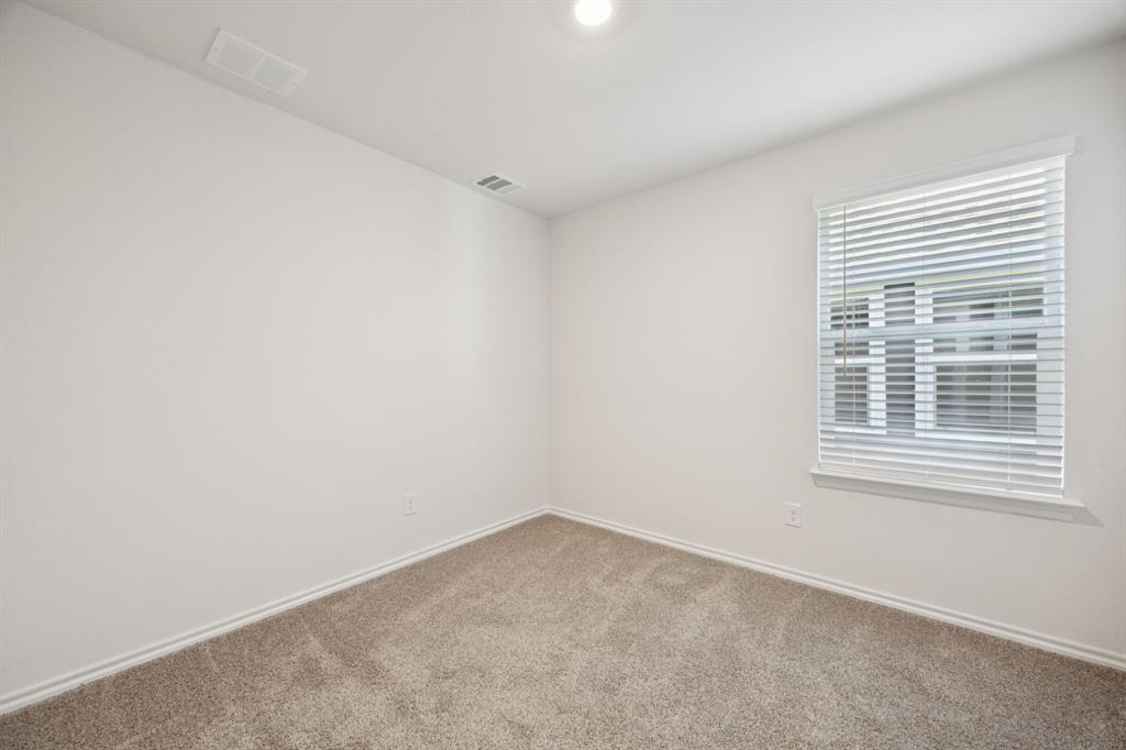 323 Clematis Street Princeton, TX 75407 - Photo 24 of 34 Carpeted spare room featuring baseboards