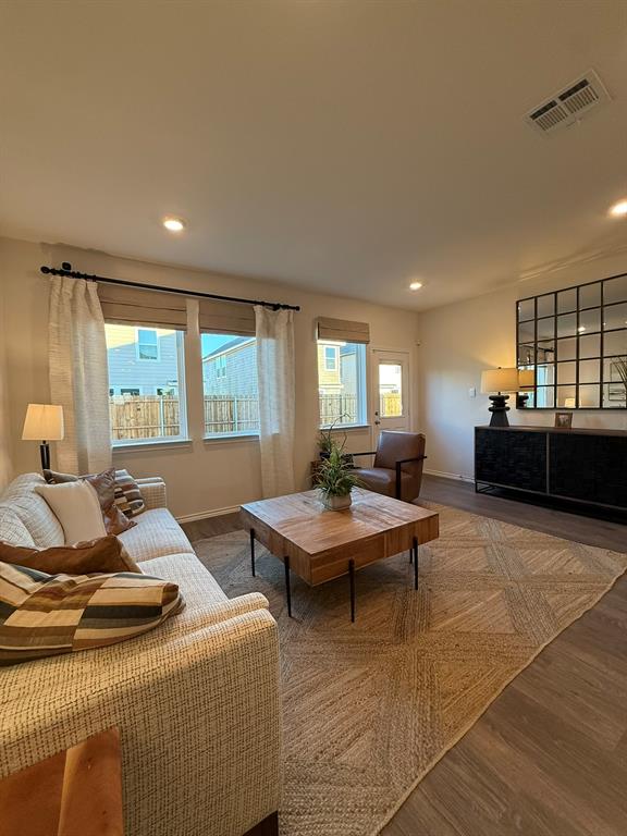 323 Clematis Street Princeton, TX 75407 - Photo 7 of 34 Living room featuring wood finished floors and recessed lighting