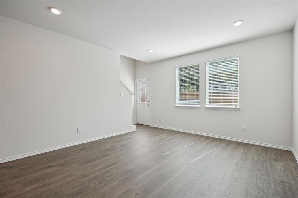 323 Clematis Street Princeton, TX 75407 - Photo 8 of 34 Unfurnished living room with dark wood finished floors and recessed lighting