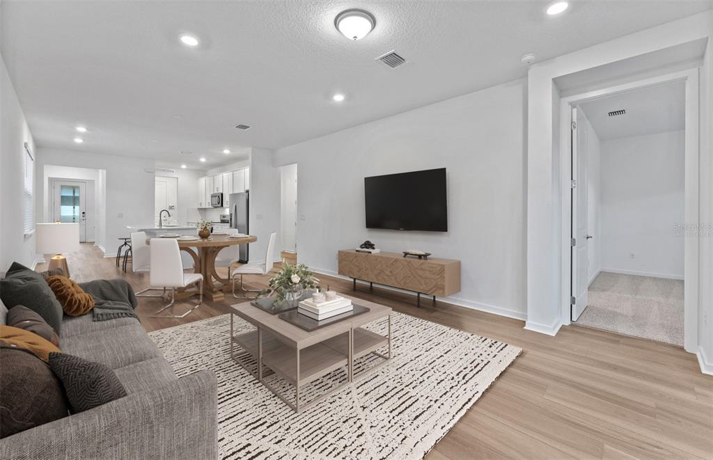 13748 Rocky Pne Place Spring Hill, FL 34610 - Photo 2 of 30 a living room with furniture and a flat screen tv