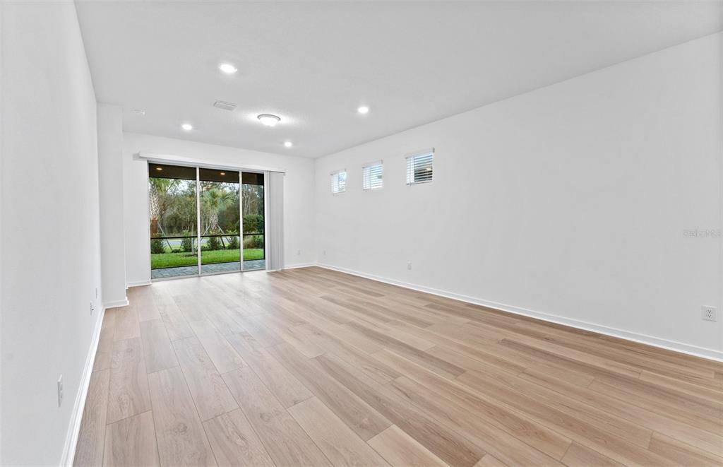13748 Rocky Pne Place Spring Hill, FL 34610 - Photo 6 of 30 wooden floor in an empty room with a window