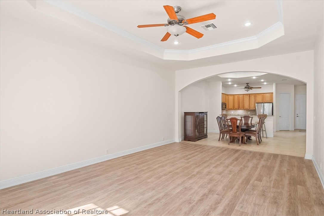 5224 Haw Branch Road Sebring, FL 33875 - Photo 11 of 40 a view of a dining room with furniture and a chandelier fan
