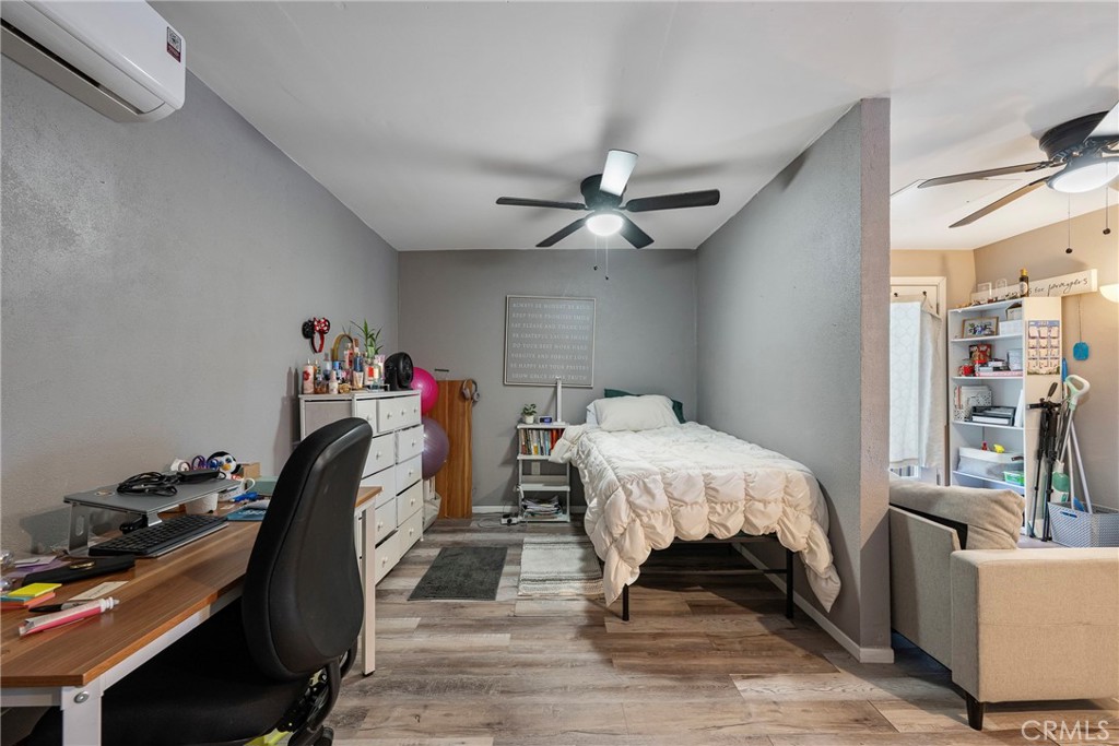 11309 Telechron Avenue, Unit B Whittier, CA 90605 - Photo 12 of 17 a bedroom with a bed and a chandelier