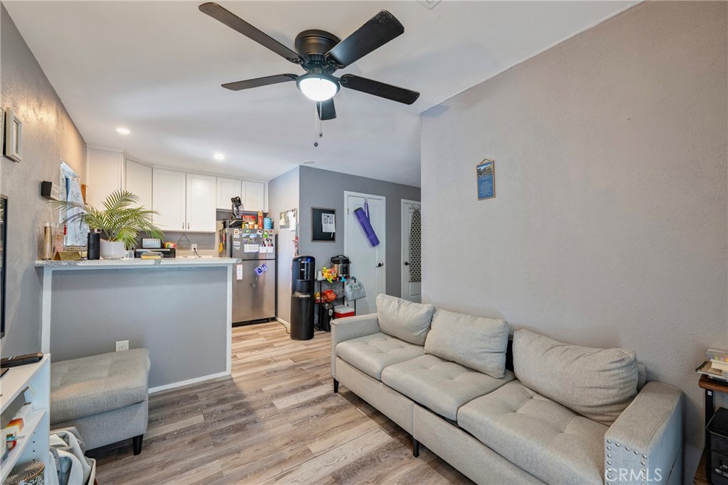 11309 Telechron Avenue, Unit B Whittier, CA 90605 - Photo 6 of 17 a living room with furniture and a wooden floor