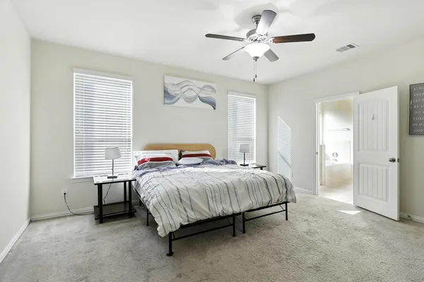 a bedroom with a bed and a chandelier