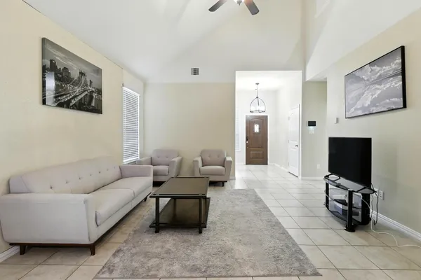 a living room with furniture and a flat screen tv