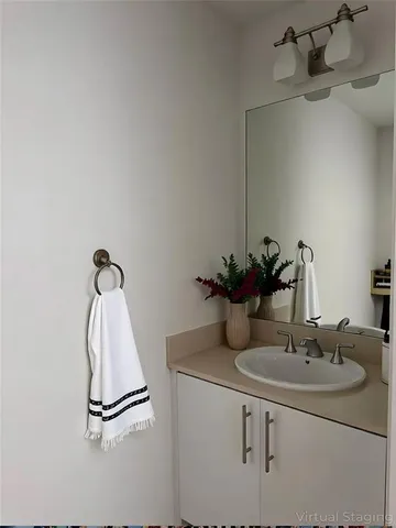 a bathroom with granite countertop a sink and a mirror