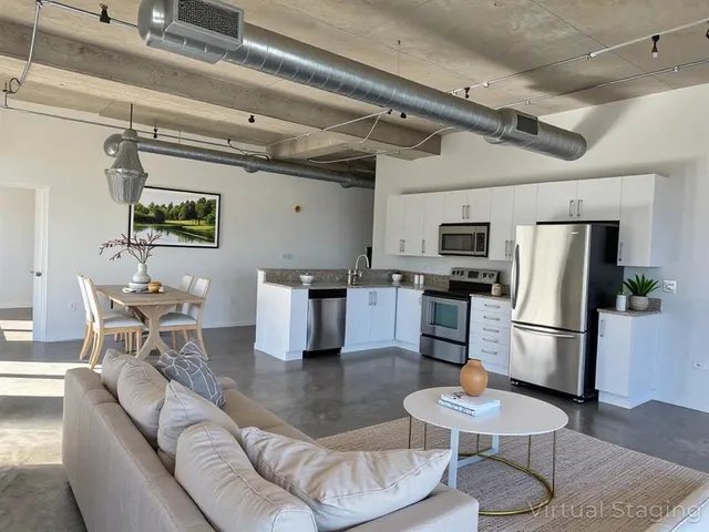 a living room with furniture and kitchen view