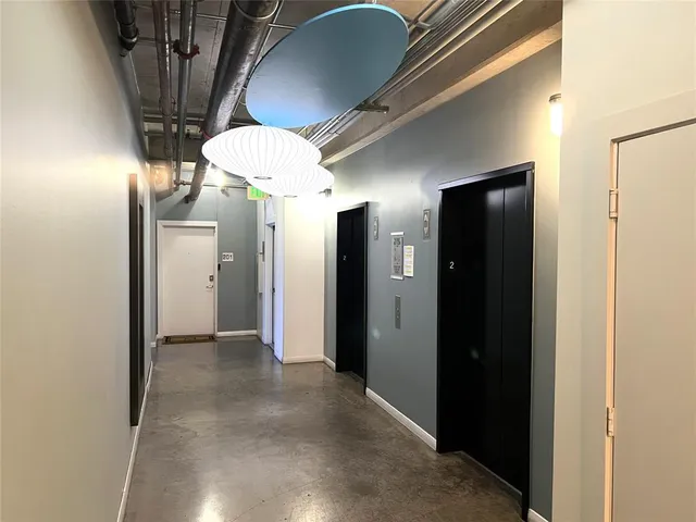 a view of hallway with chandelier