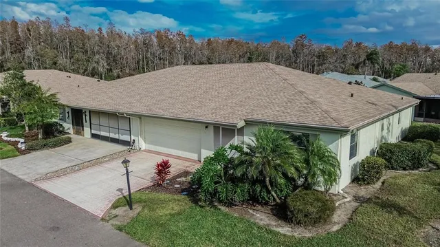a view of a house with a yard and plants