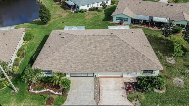 an aerial view of a house with garden space and street view