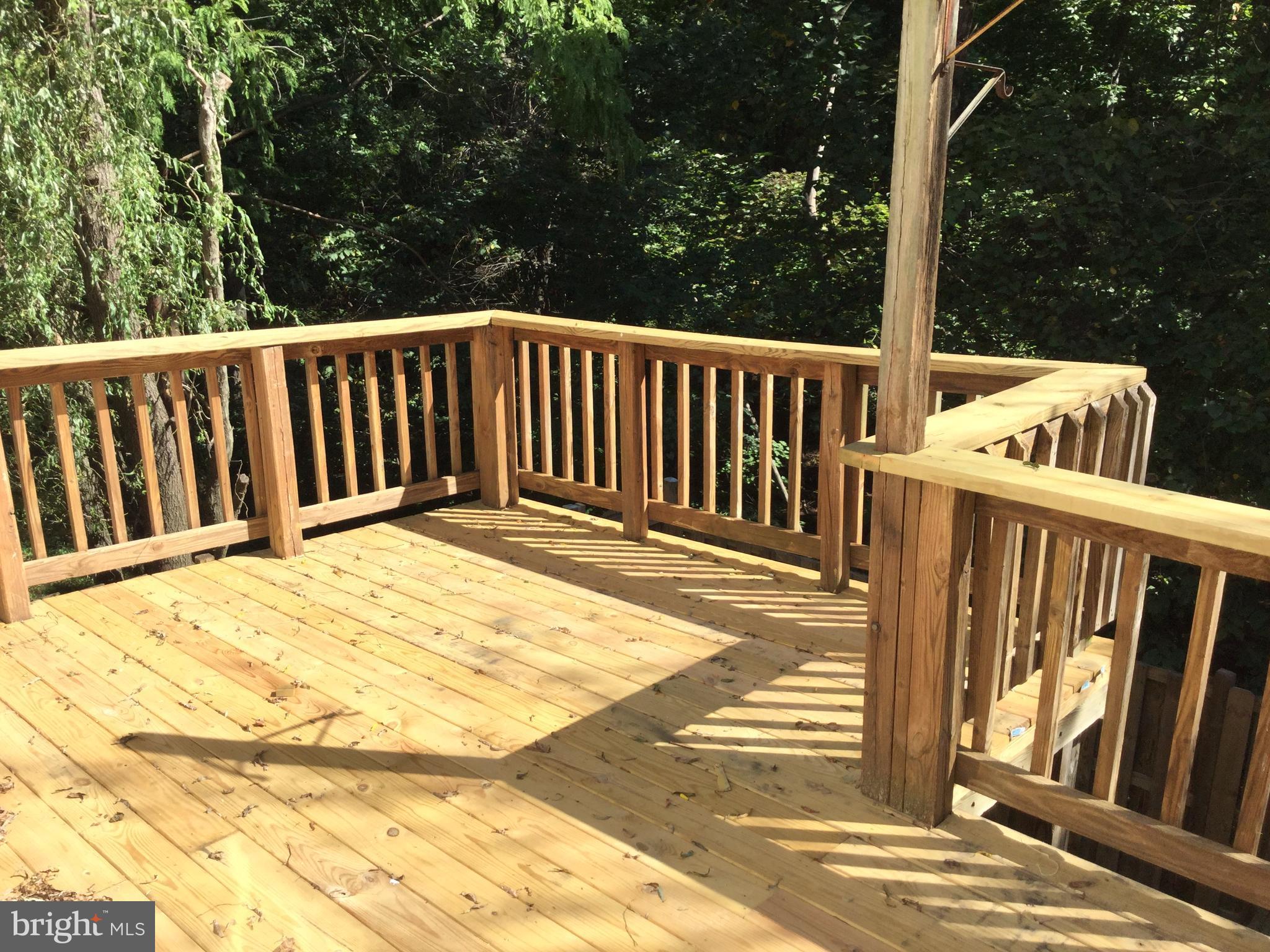 9072 Silver Maple Court Manassas, VA 20110 - Photo 14 of 14 a balcony with wooden floor and yard in the back
