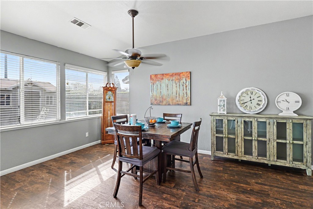 3632 Swan Court Merced, CA 95340 - Photo 13 of 50 a view of a dining room with furniture window and wooden floor