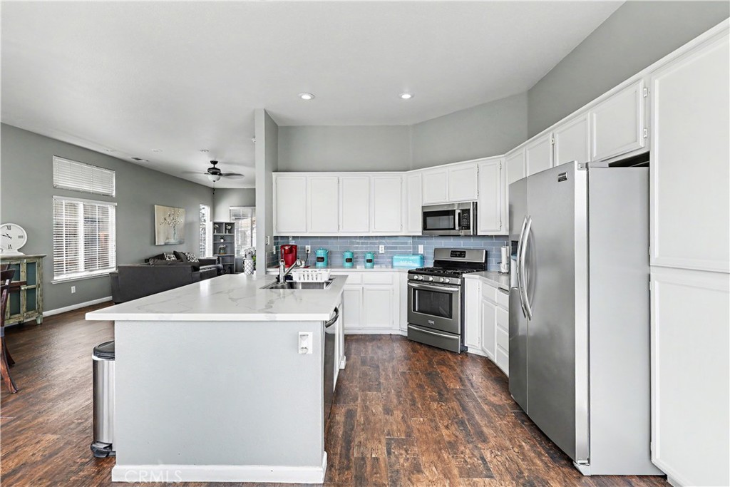 3632 Swan Court Merced, CA 95340 - Photo 24 of 50 a kitchen with stainless steel appliances a refrigerator sink and stove
