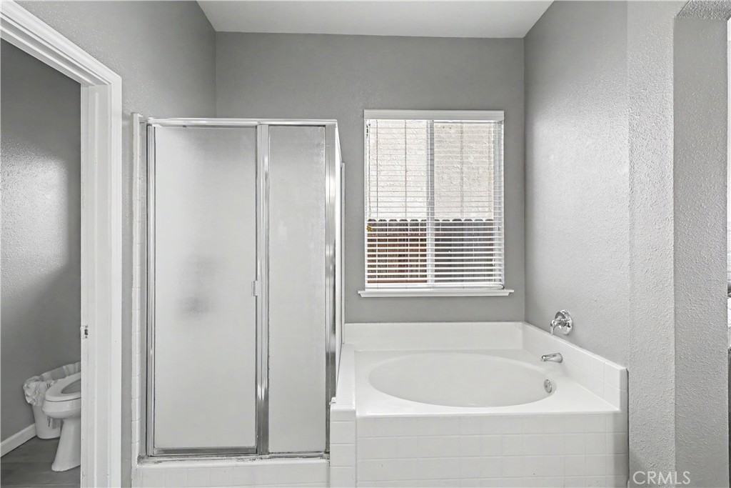 3632 Swan Court Merced, CA 95340 - Photo 29 of 50 a white bath tub sitting next to a toilet