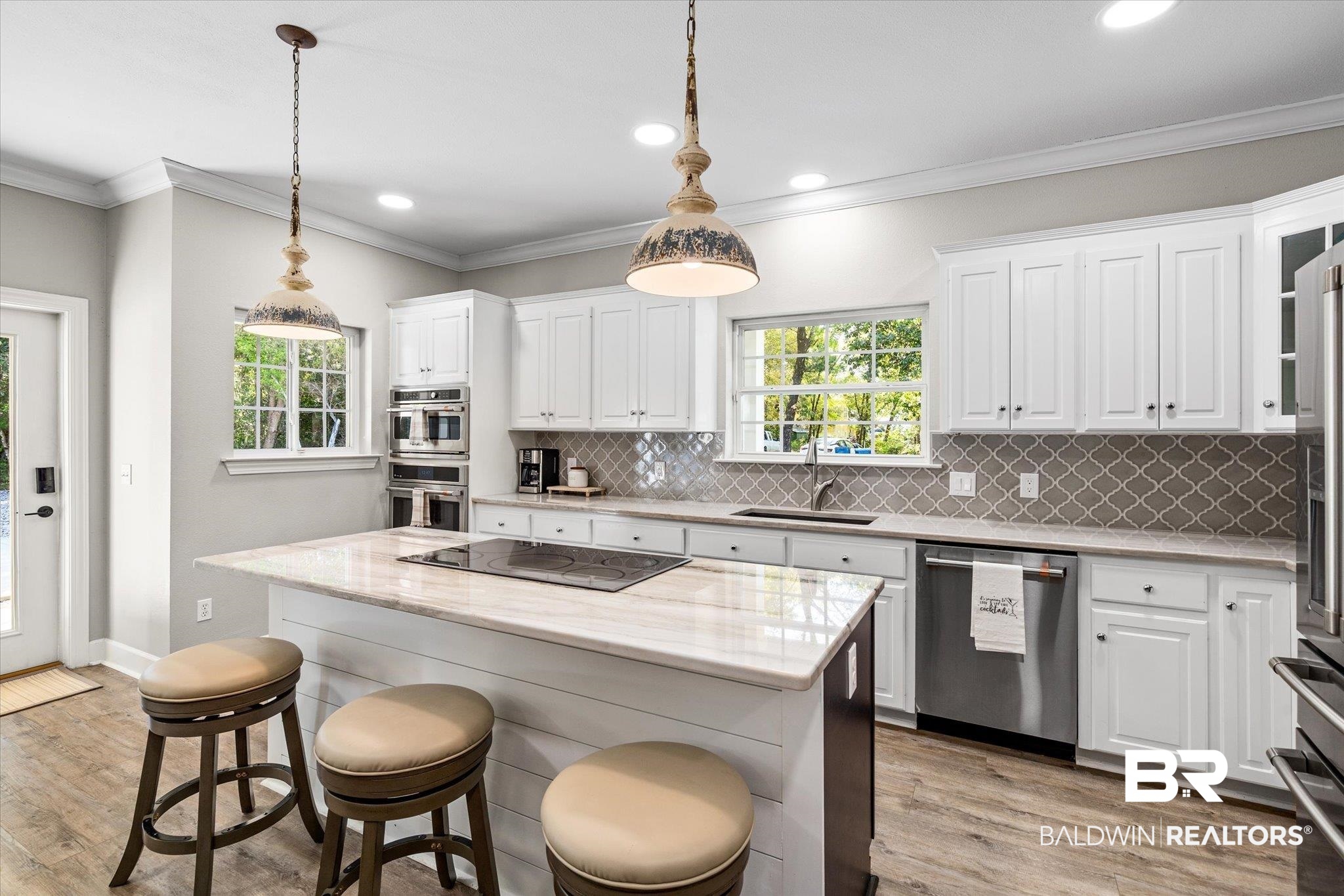 4947 Look Rook Road Orange Beach, AL 36561 - Photo 6 of 24 Kitchen with a sink, tasteful backsplash, white cabinets, and appliances with stainless steel finishes