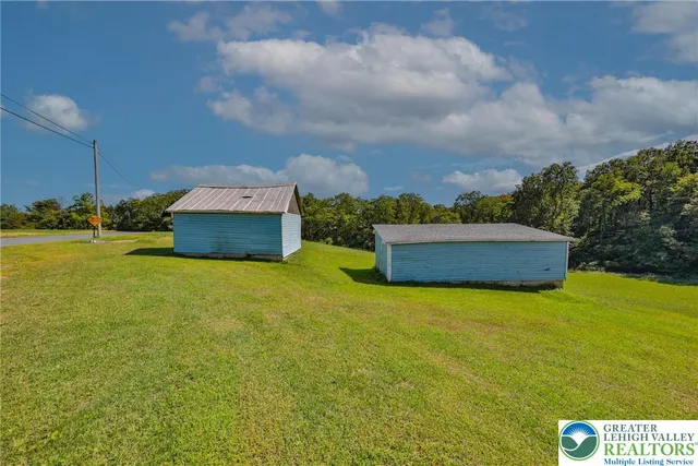 an aerial view of a house with a garden and outdoor seating