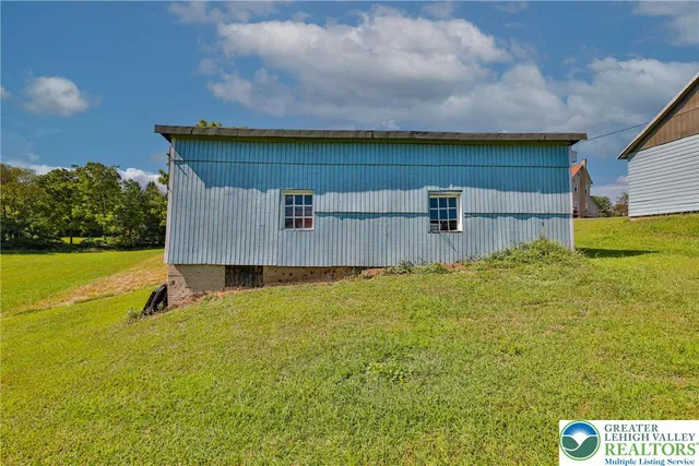 a view of a porch with furniture and a yard