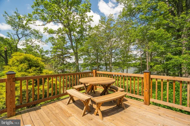 a view of balcony with wooden floor and fence