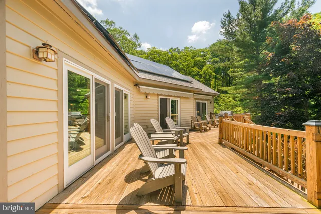 a view of a balcony with wooden floor and door