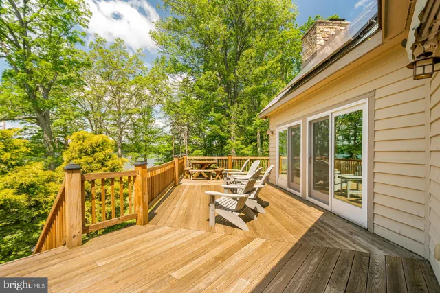 a roof deck with table and chairs and wooden floor