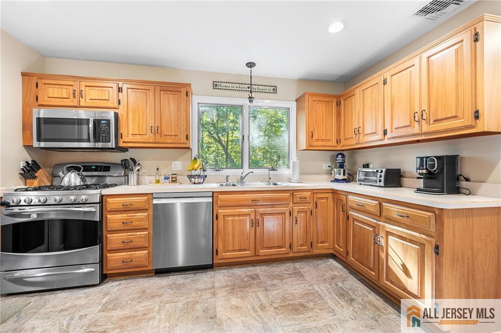 1266 Mt Vernon Road Bridgewater, NJ 08807 - Photo 14 of 44 a kitchen with stainless steel appliances granite countertop a stove a sink and a microwave
