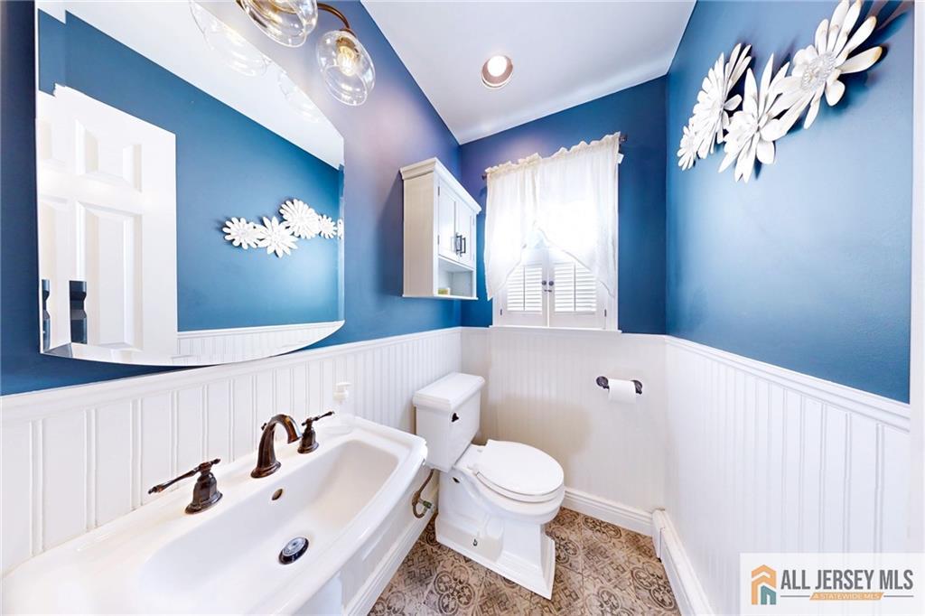 1266 Mt Vernon Road Bridgewater, NJ 08807 - Photo 15 of 44 a bathroom with a sink a toilet and a mirror