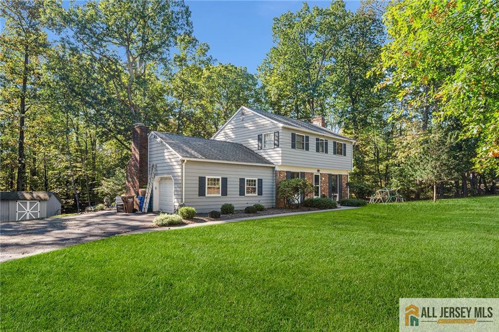 1266 Mt Vernon Road Bridgewater, NJ 08807 - Photo 2 of 44 a front view of a house with a garden and trees