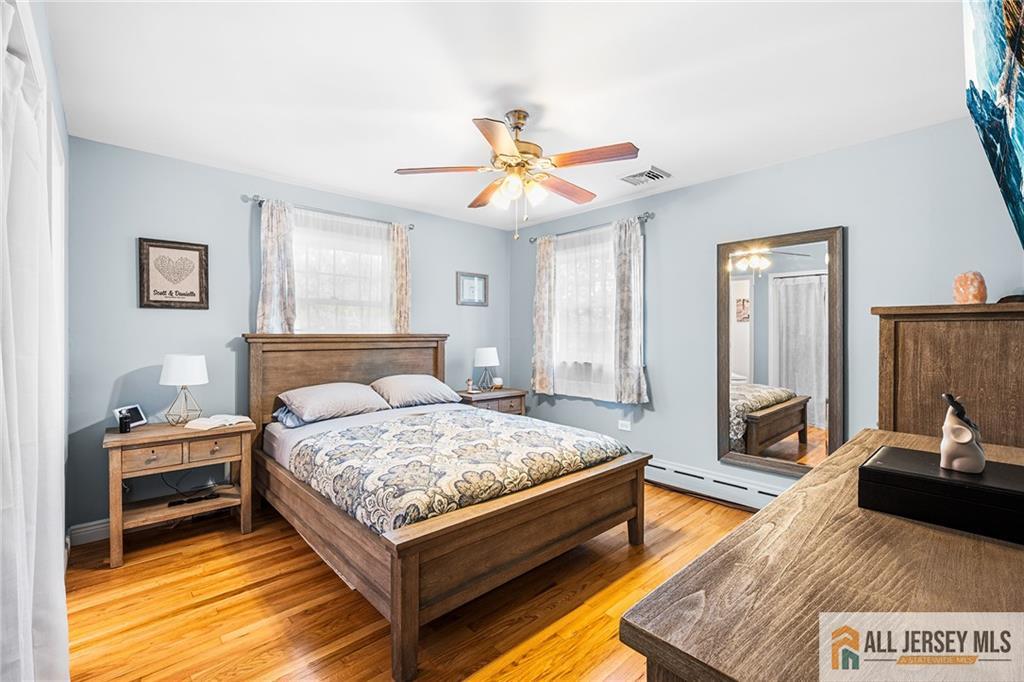 1266 Mt Vernon Road Bridgewater, NJ 08807 - Photo 22 of 44 a bedroom with a bed and a chandelier