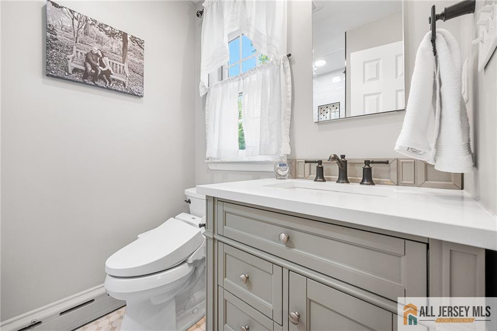1266 Mt Vernon Road Bridgewater, NJ 08807 - Photo 26 of 44 a bathroom with a toilet sink and mirror