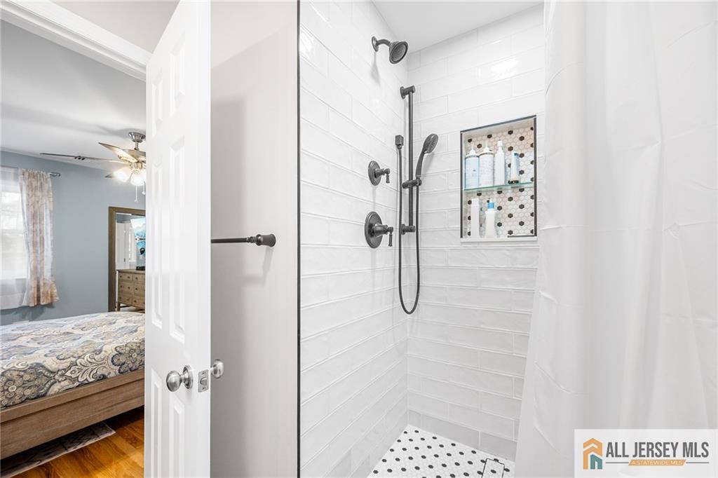1266 Mt Vernon Road Bridgewater, NJ 08807 - Photo 27 of 44 a bathroom with a granite countertop shower a sink and a mirror