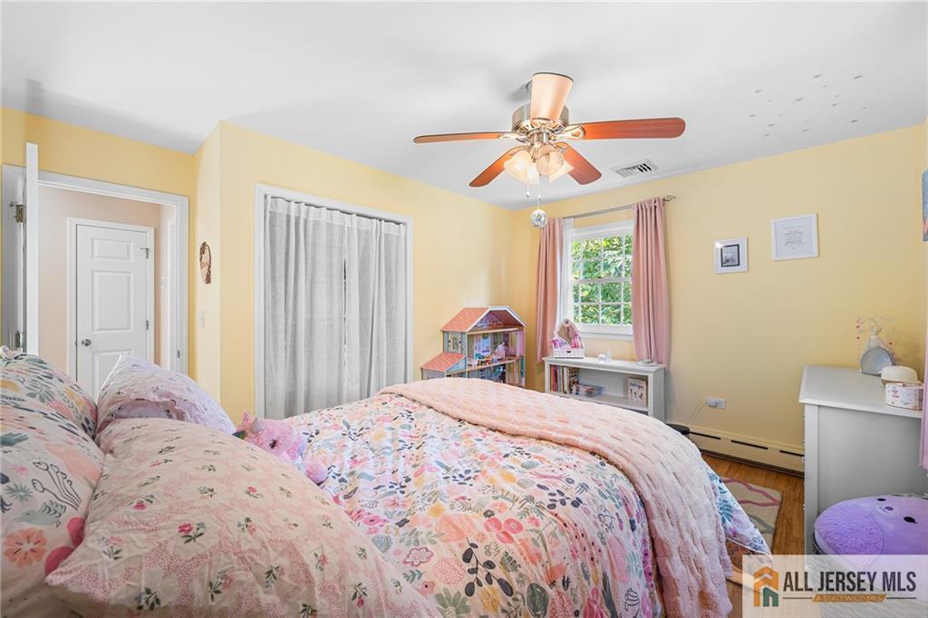 1266 Mt Vernon Road Bridgewater, NJ 08807 - Photo 29 of 44 a bedroom with a bed and a chandelier