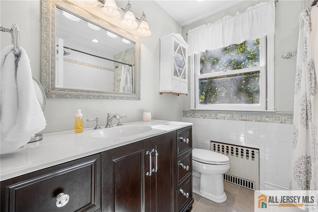 1266 Mt Vernon Road Bridgewater, NJ 08807 - Photo 33 of 44 a bathroom with a sink a toilet and a window