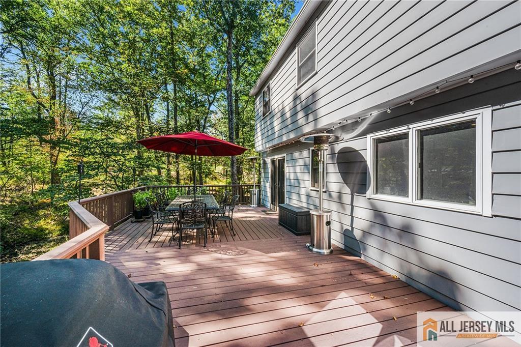 1266 Mt Vernon Road Bridgewater, NJ 08807 - Photo 37 of 44 a balcony with furniture and umbrella