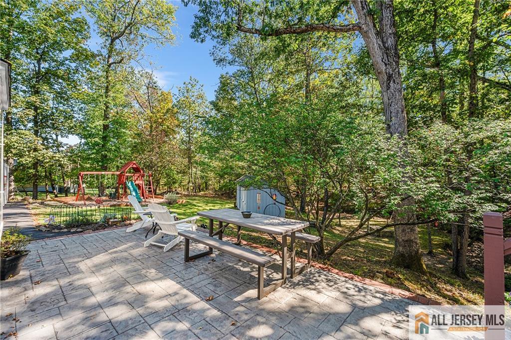1266 Mt Vernon Road Bridgewater, NJ 08807 - Photo 38 of 44 a view of a backyard with a bench and a tree