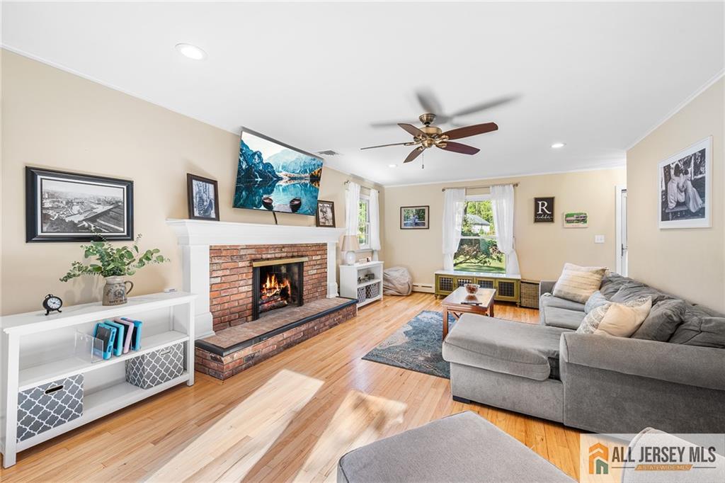 1266 Mt Vernon Road Bridgewater, NJ 08807 - Photo 8 of 44 a living room with furniture a fireplace and a large window