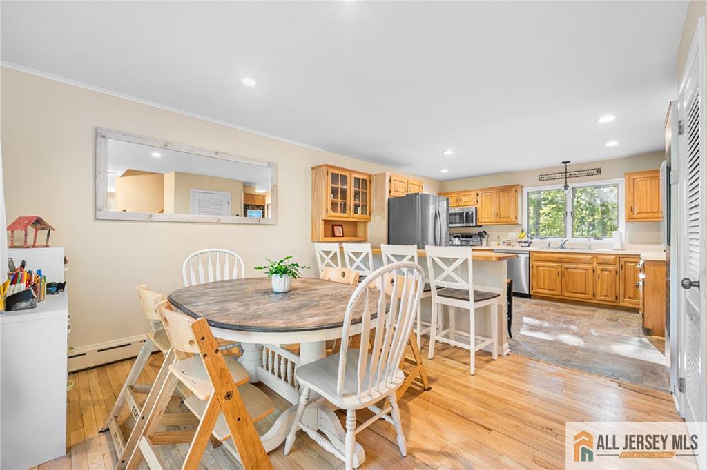 1266 Mt Vernon Road Bridgewater, NJ 08807 - Photo 9 of 44 a view of a dining room with furniture and a wooden floor