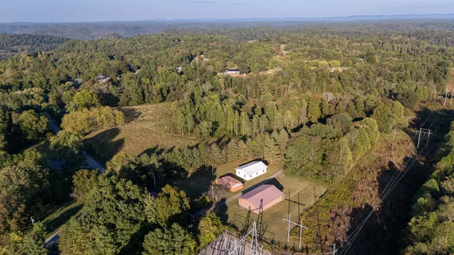 an aerial view of a house with a yard