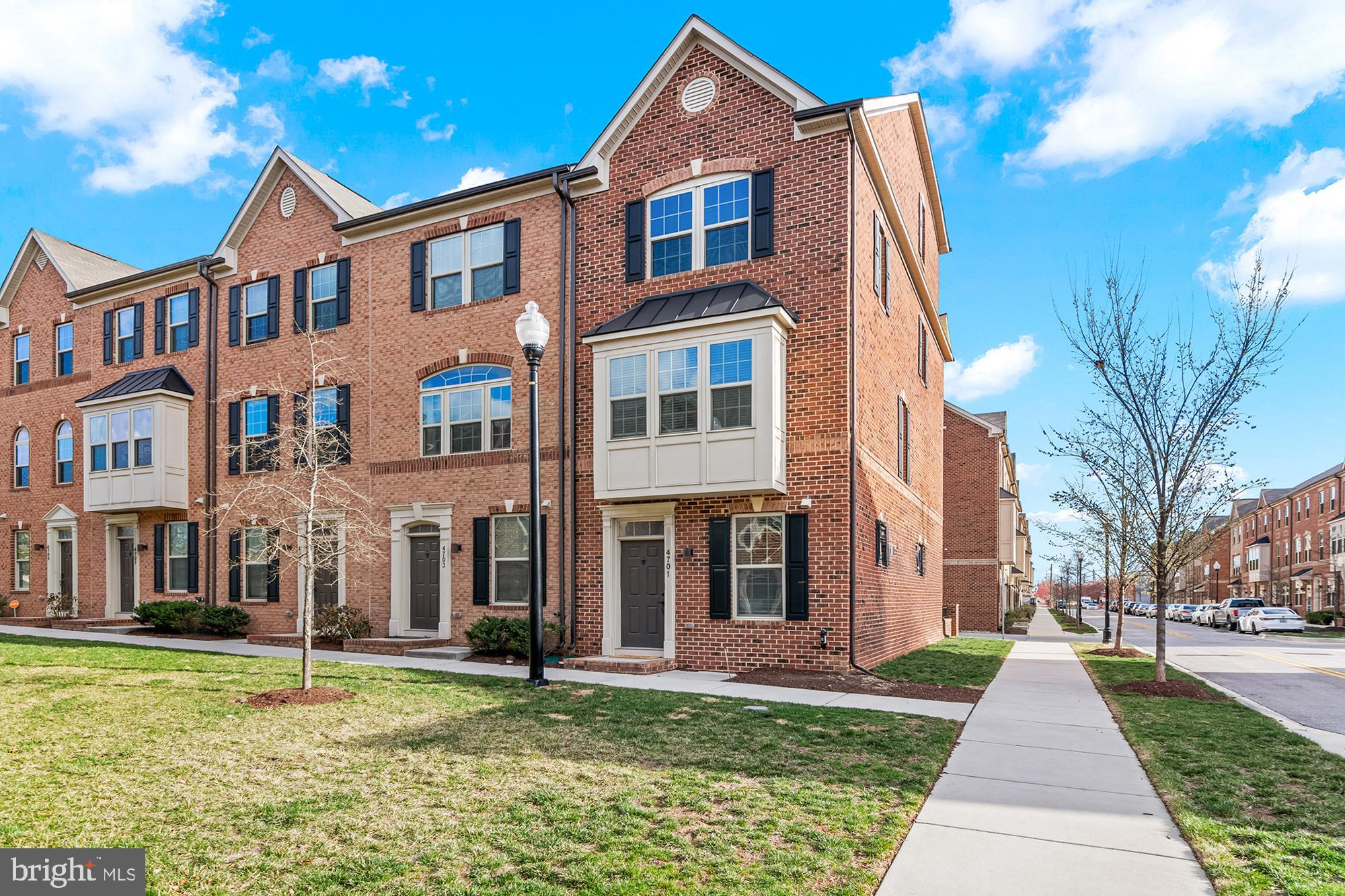4701 Marlene Mews Baltimore, MD 21224 - Photo 1 of 39 a front view of a residential apartment building with a yard