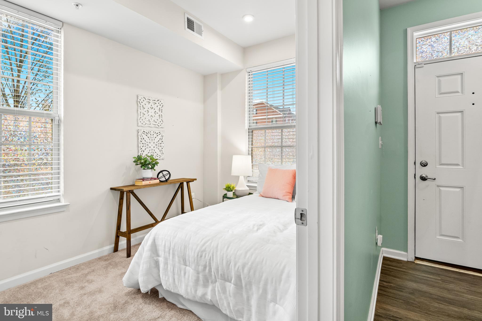 4701 Marlene Mews Baltimore, MD 21224 - Photo 34 of 39 a bedroom with a bed table and chair