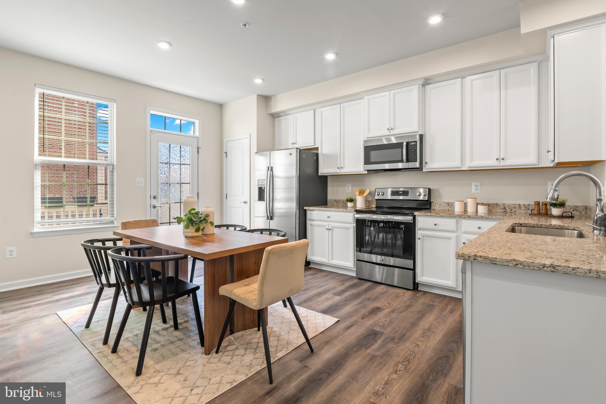 4701 Marlene Mews Baltimore, MD 21224 - Photo 4 of 39 a kitchen with stainless steel appliances granite countertop a stove a sink a microwave and a refrigerator