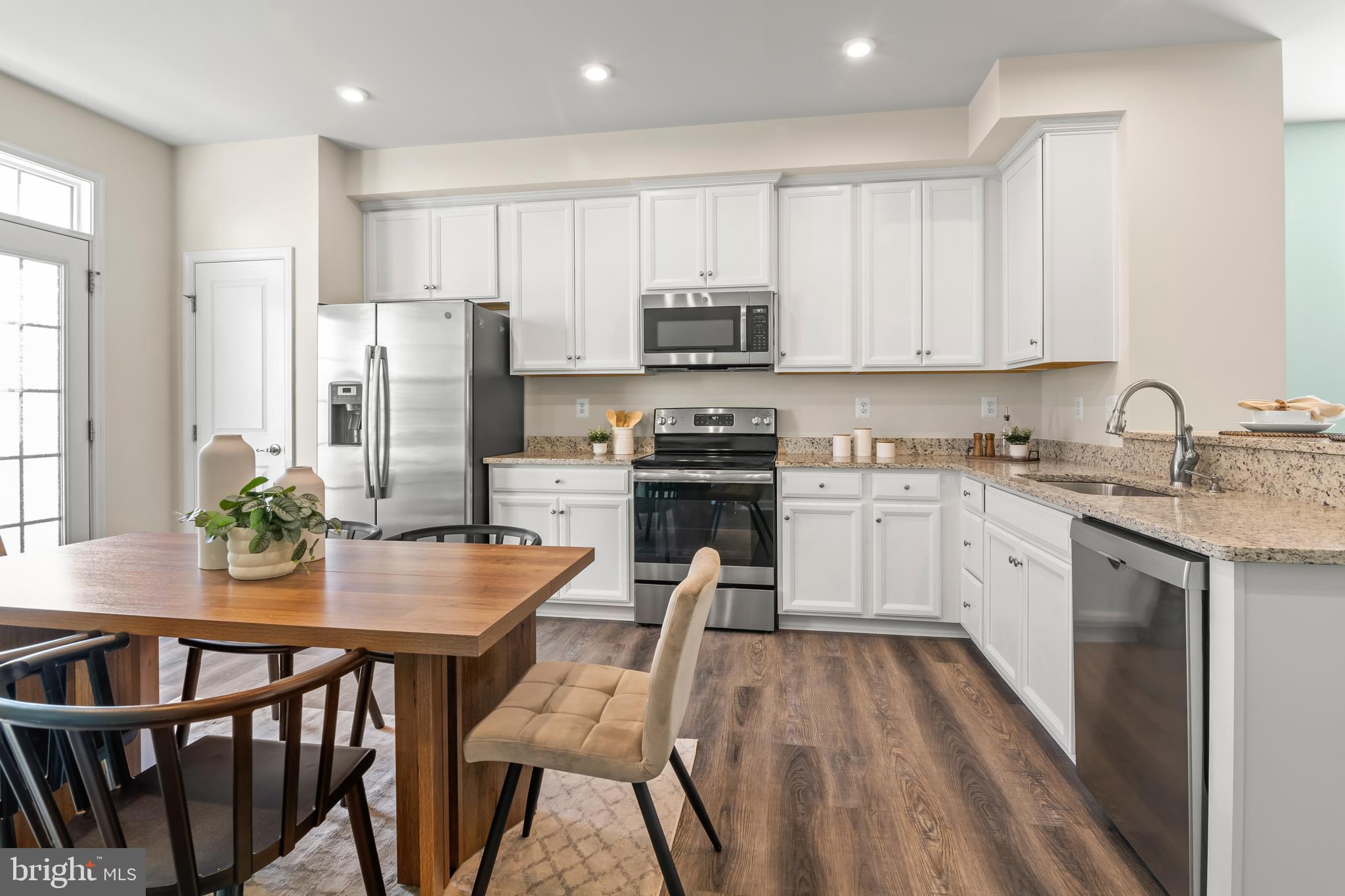 4701 Marlene Mews Baltimore, MD 21224 - Photo 6 of 39 a kitchen with white cabinets and stainless steel appliances