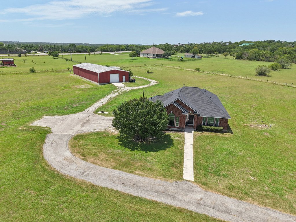 401 Southern Drive Buda, TX 78610 - Photo 1 of 1 an aerial view of a house with a yard and lake view